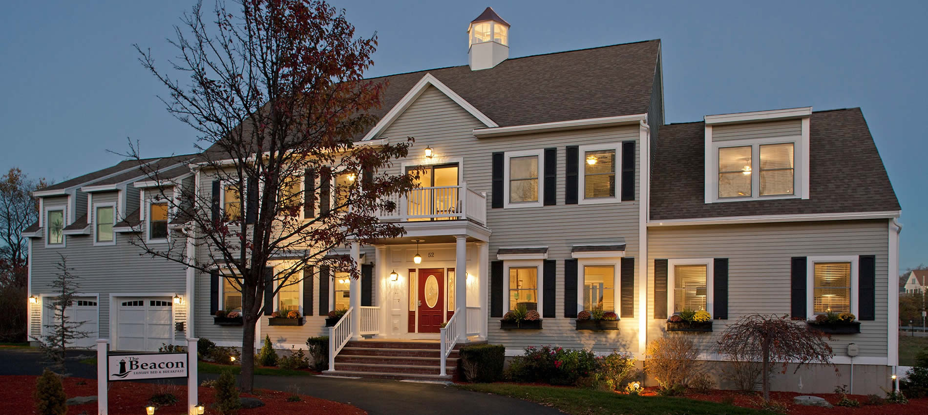 beacon waterfront inn front of home at twilight