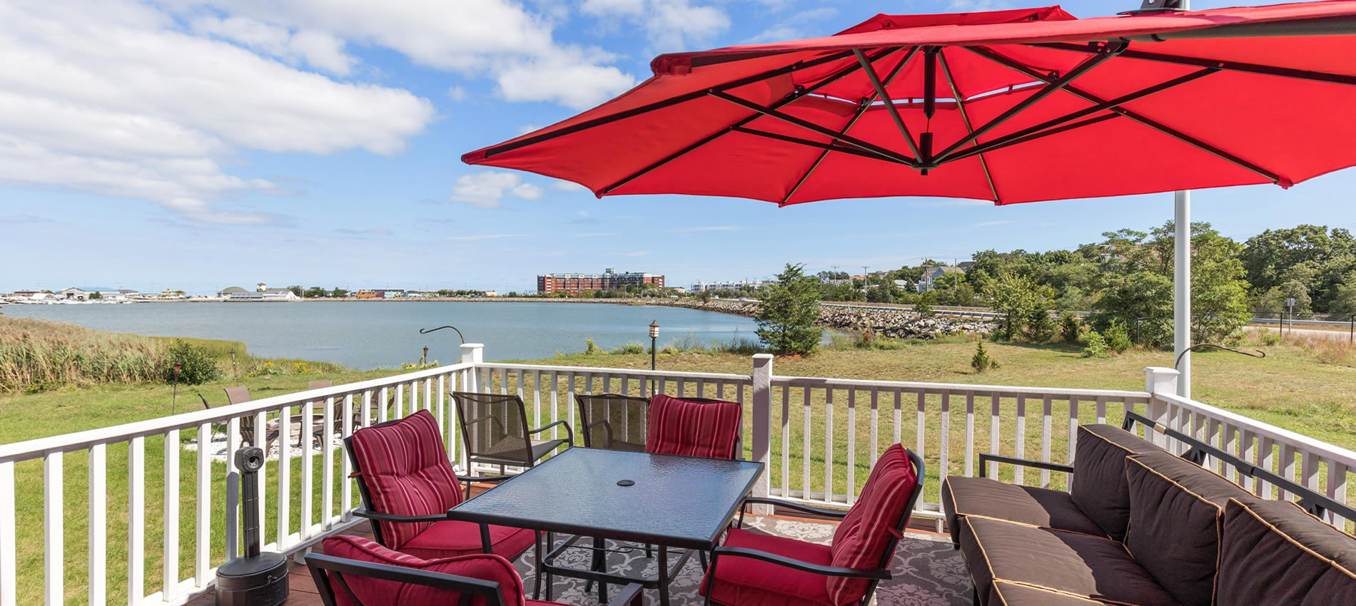 beacon waterfront inn in hull ma deck and chairs with umbrella overlooking water