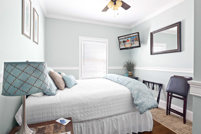 guest room with bed, fireplace, table and chairs