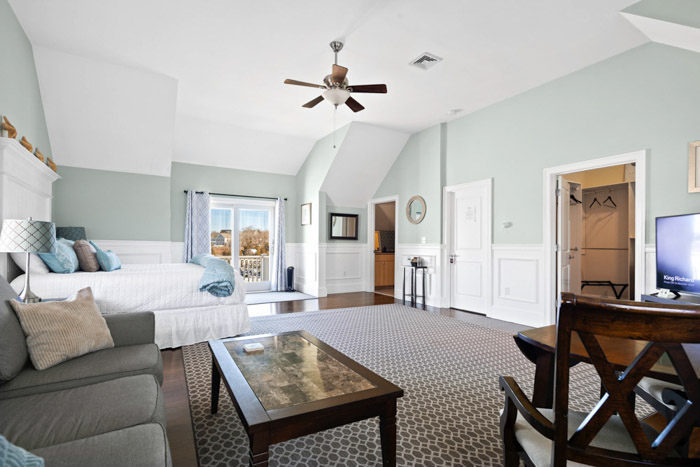 guest room with bed, fireplace, table and chairs